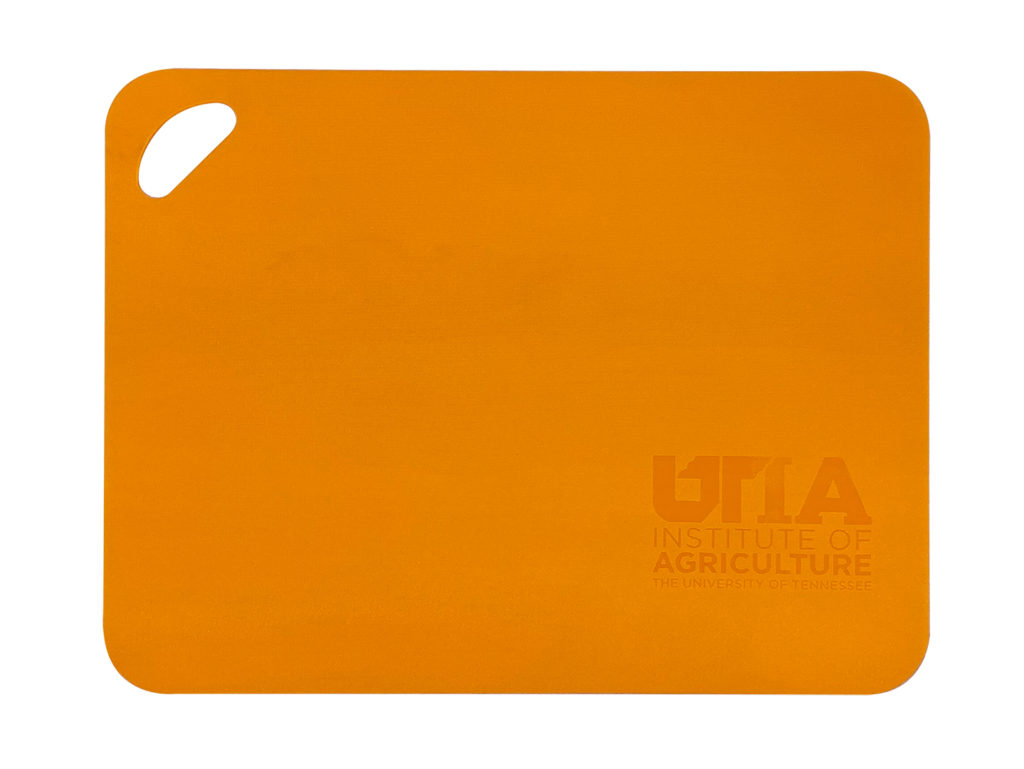 Orange cutting board with the UTIA logo embossed in the bottom right corner