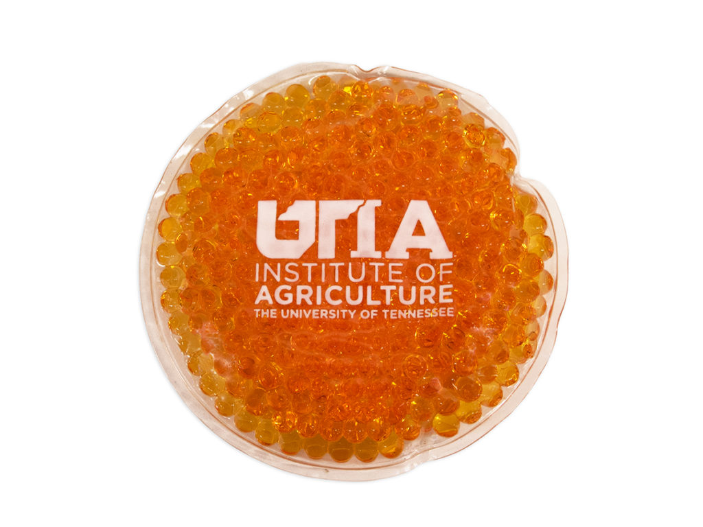 Orange hot/cold pack with a white UTIA logo