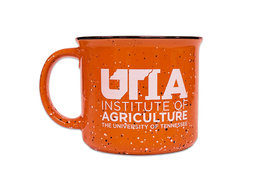 Orange speckled mug with cream interior and UTIA logo