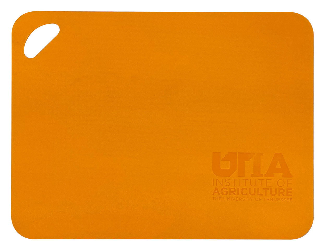 Orange cutting board with the UTIA logo embossed in the bottom right corner